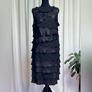 Black, tiered ruffle cocktail dress. Sleeveless with beaded detail at neckline.